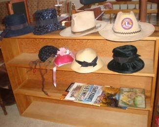 Four foot long wood book shelf. Ladies and men's hat's, including a Lions Club hat. How to draw, paint books.