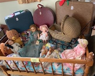 Suitcases, dolls, wicker doll buggy, barbies & clothes, other doll clothes, toddler bed.