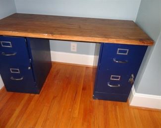 TWO FILE CABINETS USED AS LEGS TO FORM A DESK