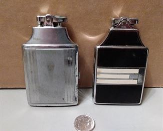 Large Ronson cigarette lighters and they both open to hold cigarettes 