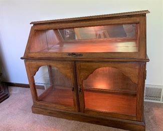 Beautiful oak display / curio cabinet.  Light on the top and bottom cabinet.