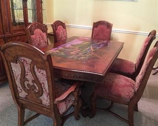 Double pedestal carved wood dining table has 2 leaves and 6 chairs