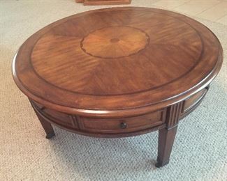 Inlaid design coffee table has 4 drawers around sides