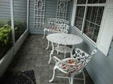 white, iron patio set
2 seater bench, 2 arm chairs, round table