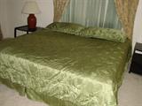 Queen size bed, green silky comforter and shams