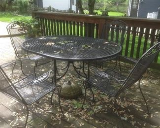 Wrought iron table with 4 chairs....presale $125 also has umbrella and umbrella stand