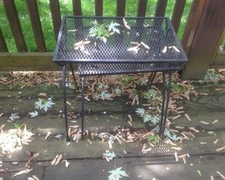 Two nesting wrought iron tables.