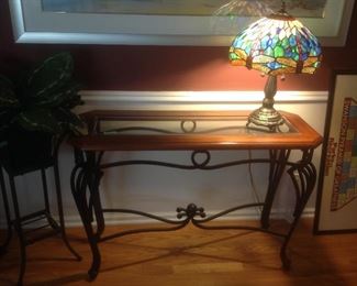 Wood and glass top with iron base sofa table.  Measures 42" long x 16" deep x 28" tall