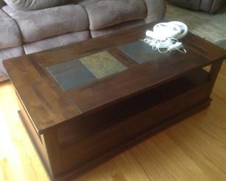 Three piece coffee/end table set.  Coffee table measures 48" long x 24" wide x 19" tall.  Wood with slate insets