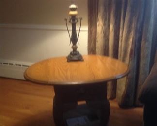 Oak end table that fold down ...26" long x 18" w x 24" tall.  Becomes 32" wide with sides up.