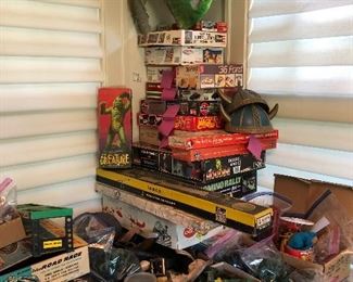 stack of vintage toys, soldiers, military vehicles, toy guns