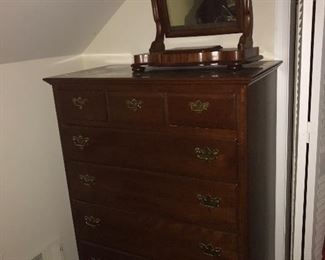 Chest of drawers with vanity mirror.