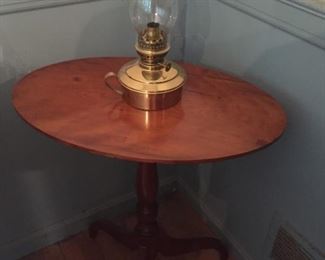 Round Table and Brass Oil Lamp.
