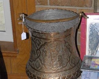 Elaborate scenes etched into this copper bin