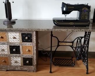 Singer 100th Anniversary edition sewing machine on custom granite table with antique treadle base.