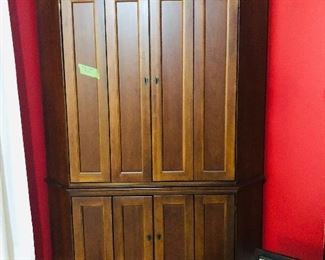 Gorgeous Hooker Corner Entertainment Piece.  It is rare to find a space saving corner entertainment piece that is gorgeous.  This Hooker piece fits the bill with doors that open to reveal space for TV, a built in plug in and shelving units on the bottom.