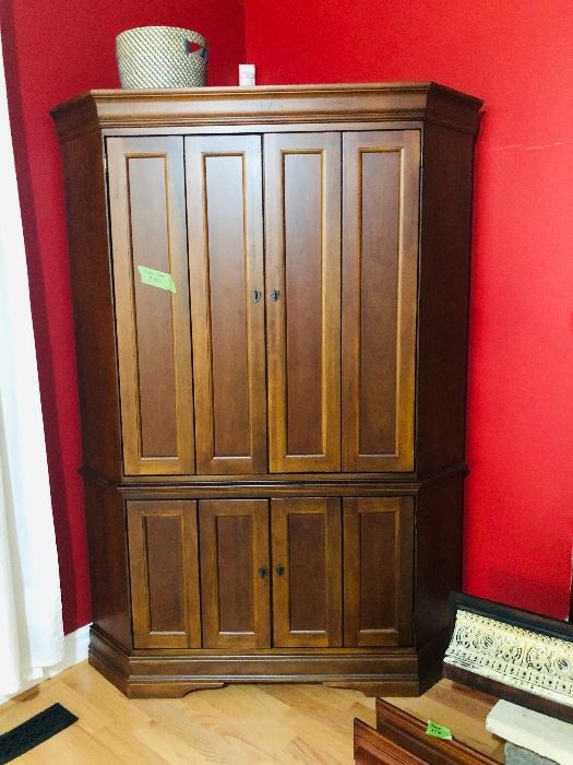 Gorgeous Hooker Corner Entertainment Piece.  It is rare to find a space saving corner entertainment piece that is gorgeous.  This Hooker piece fits the bill with doors that open to reveal space for TV, a built in plug in and shelving units on the bottom.