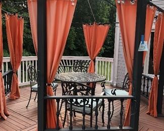 This beautiful gazebo as seen is for sale.  Comes with curtains that are for the outdoors and the gazebo is trimmed with tiny white lights.  Also for separate purchase is this lovely 5 piece Round Table Patio Set.