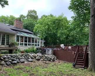 Back of house and deck- 4 BR, 2 1/2 tile Baths; Fireplace in Great Room and 4 seasons' Sun Room. Cathedral Ceiling, Large Mudroom/Laundry Room. Swin spa pool and hot tub-huge deck. 1 Acre, plus
