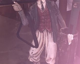 Statue of golf figure. Holds cue sticks