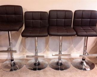 Four pleather adjustable bar stools in excellent condition!