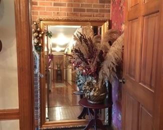 Large (gold) Floor Mirror, small round table, floral arrangement