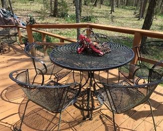 2 sets of outdoor wrought iron tables, each with 4 chairs