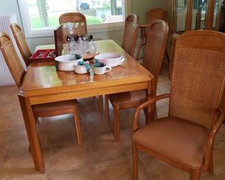Table with 6 caned back chairs, and leaves.  Note, there is some minor damage to the backs of at least one chair....