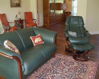 Ekorne green leather loveseat, and one of a pair of Stressless recliner and ottomans. Leather side chairs in background