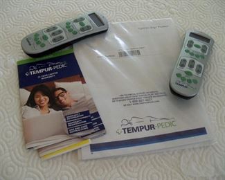 remotes and paperwork for Tempur Pedic.  Two extra-long twins pushed together.