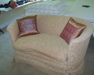 curved love seat with down cushions, perfect in the boudoir