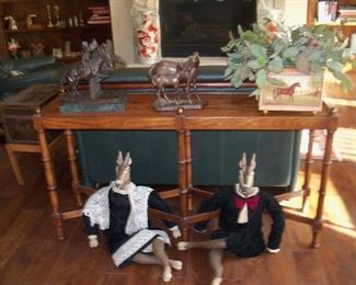 sofa table , horse decorations, and a pair of deer all dressed up