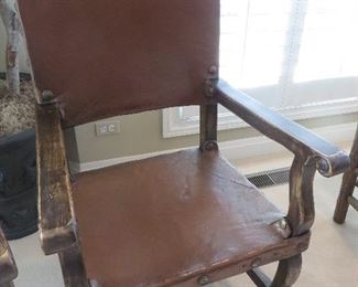 SPANISH COLONIAL LEATHER OAK SIDE CHAIR
BROWN LEATHER LINED WITH LARGE BRASS TACKS EMBELLISHED WITH CARVED FINIALS