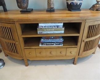 DEMILUNE CONSOLE HAVING TWO CENTER SHELVES ABOVE FIVE PIGEON HOLE DRAWERS
FLANKED BY SPINDLE DOORS