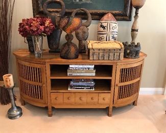DEMILUNE CONSOLE HAVING TWO CENTER SHELVES ABOVE FIVE PIGEON HOLE DRAWERS
FLANKED BY SPINDLE DOORS
