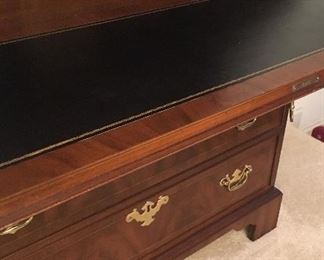 Leather writing surface of secretary bookcase