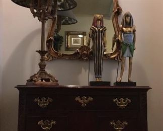 Queen Anne occasional table; gilded mirror; table lamp; Egyptian figurines