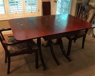 1957 Lexington Chair Co. Duncan Phyfe Mahogany drop leaf dinning table with 2 leaves. Included are Two arm chairs.