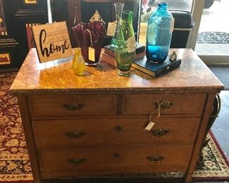 Vintage 4-Drawer Oak Chest with Ornate Hand Carved Detailing on bottom and Marble Top, Along with Blenko Blue Glass Bottle, Murano Green Glass Vase, Watra Red Scalloped Vase, & Others...