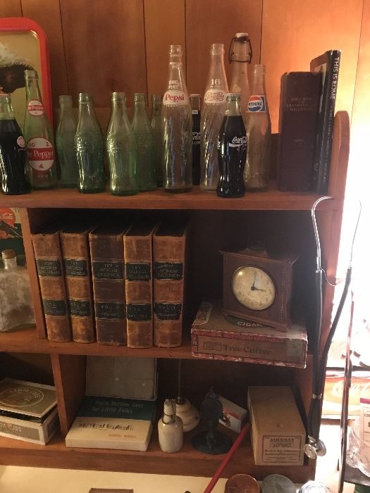 Some of the many leather bound books, bottles, clocks