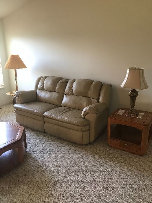Taupe/Beige Leather sofa! Flanked by a Oak end table with drawer on one side and a lamp/table on the other!