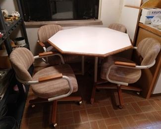Vintage 80's white formica octagon table with 1 leaf and 4 upholstered chairs on rollers