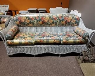 #127 Wicker couch with flower cushions 8' (heavy) $200.00