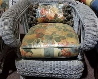 #128 Wicker chair with flower cushion and rounded armrest as is (heavy) $75.00