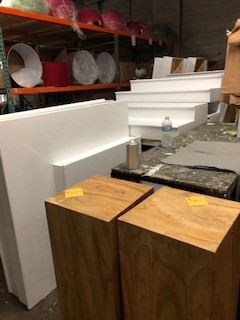 Wood pedestals, steps, red lamp shades.