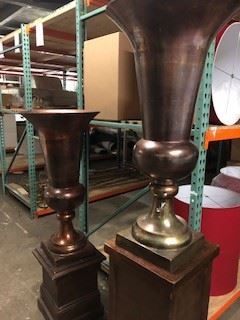 Oversized urns on pedestals.