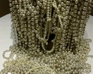Garlands, ropes and necklaces of faux pearls.
