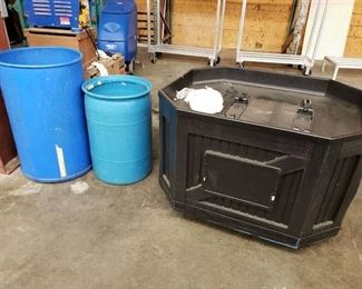 Display table and 2 blue trash bins