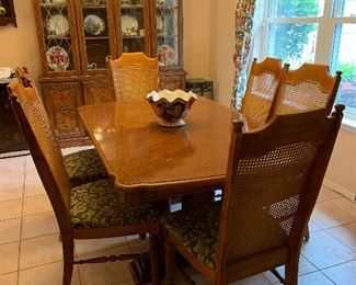 Burled wood trimmed pecan dining table with 6 chairs and 1 leaf. Excellent condition. 