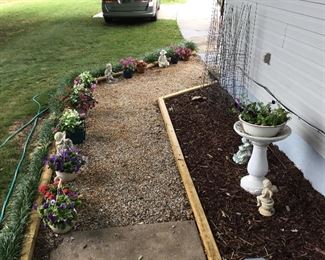 Yard Art and Assorted Flowers in Pots along walkway leading to the back yard Deck.